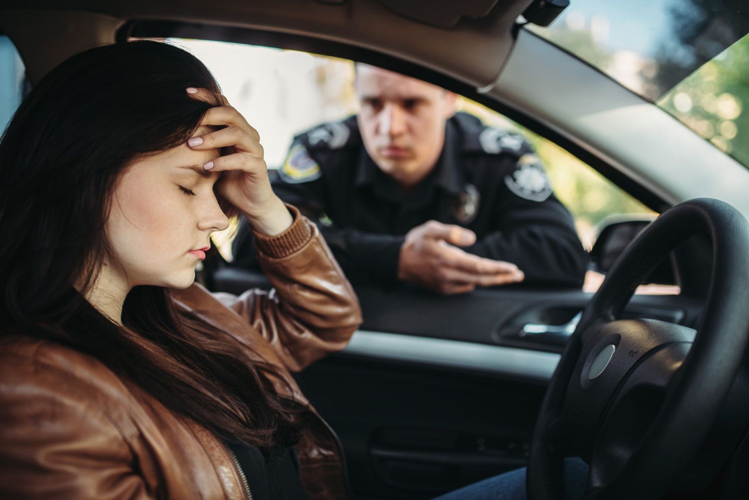 A woman is being pulled over for a DUI